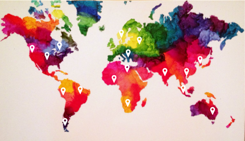 The image shows three individuals seated around a table, engaged in examining old photographs.